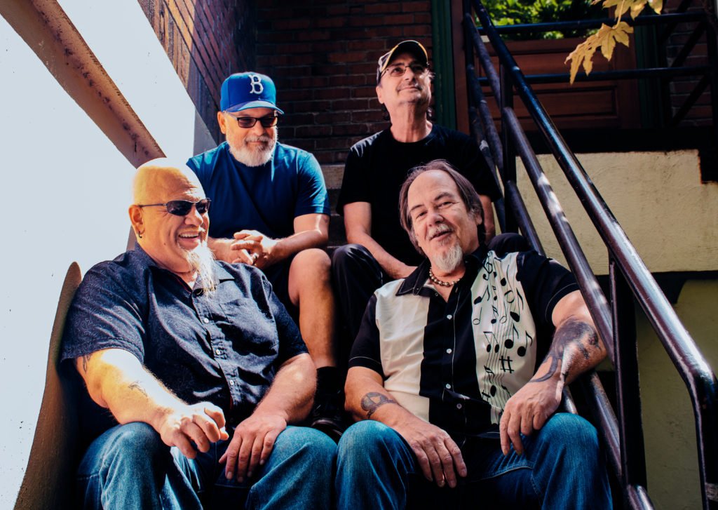 Members of the band sitting on stairs, (t-l/r) John Kunz, Tony Harris (b-l/r) Scott Alexander, Matt Thom